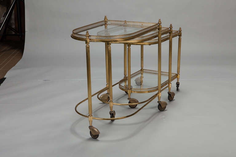 French Three Piece Neoclassical Brass and Glass Nesting Tables on Casters