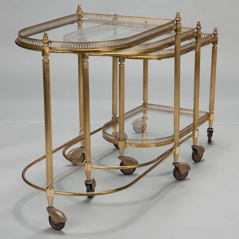 Mid-20th Century Three Piece Neoclassical Brass and Glass Nesting Tables on Casters