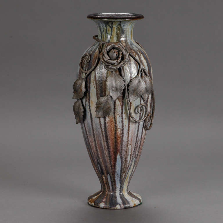 Tall vase by Belgian artist Roger Guerin in streaky blue gray glaze with beautifully detailed iron overlay of rose blooms and leaves, circa 1930s. Incised signature on the bottom.