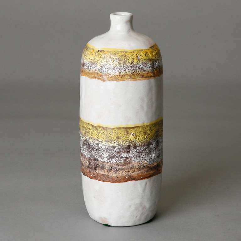 Circa 1960s tall Italian vase by Arno Collective outside of Montelupo, Italy with a base glaze of bone white and free-form banded stripes of gold, lavender and rust. Original Raymor label affixed to bottom.