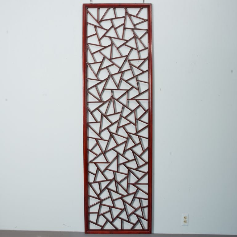 This antique Chinese screen door panel has a red finish and an abstract, open work design. Two available. Priced and sold individually.