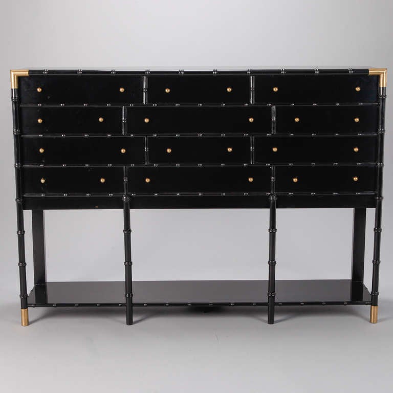 English wood faux bamboo chest of drawers has been refurbished with a fresh, ebonized finish, brass hardware and is mounted on a new, custom-made Stand/base to give this piece additional height and stature, circa 1920s.