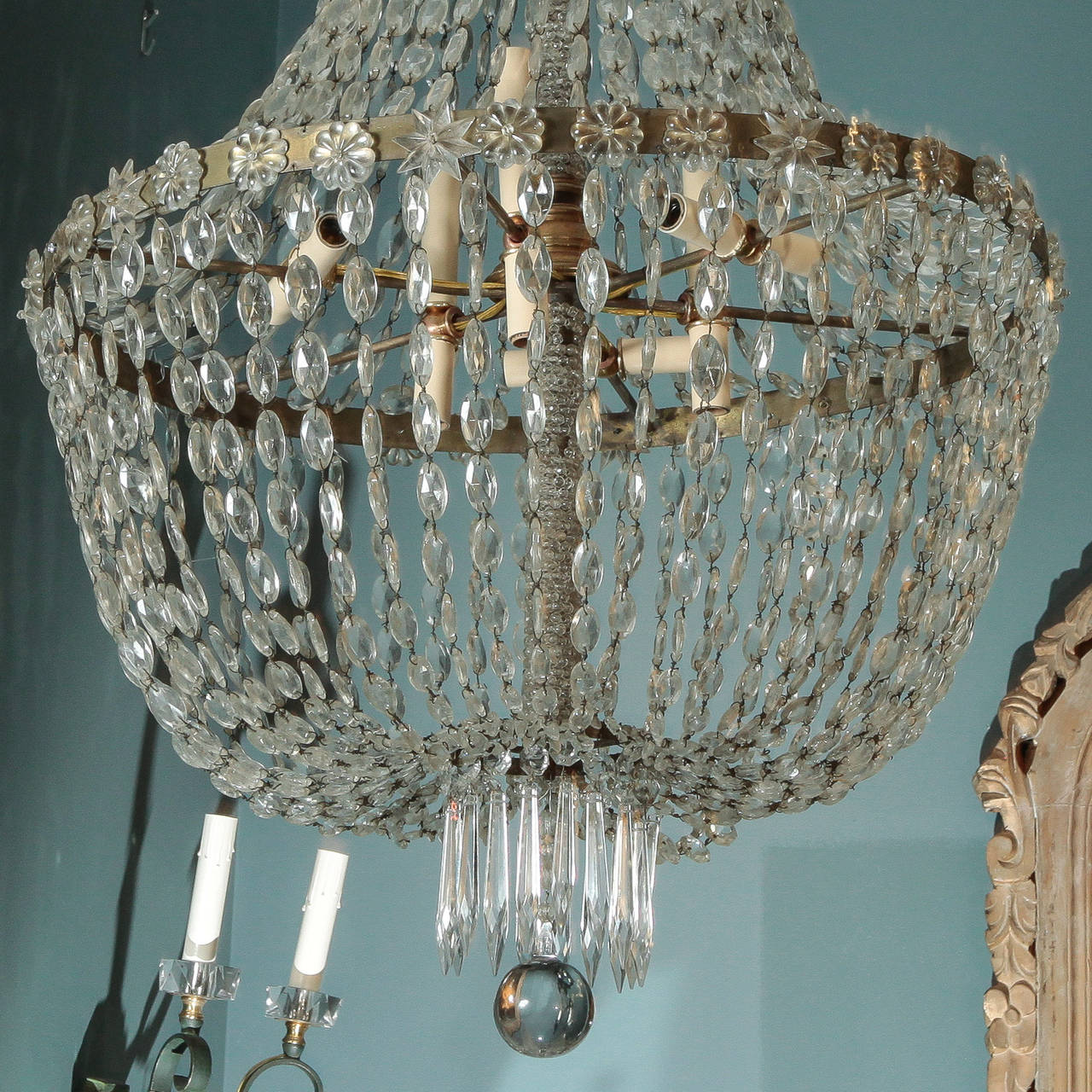 Found in France, this extra large all crystal chandelier dates from approximately 1900 and has a basket shaped brass frame draped with oval shaped, faceted crystal beads.  At the bottom is a fringe of dagger shaped crystal pendants surrounding a