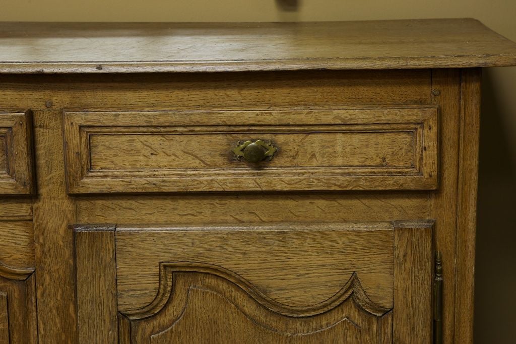 This 19th century cabinet has three functional drawers over a two door hinged cabinet with one interior shelf. Center drawer and cabinets locks work with skeleton keys.