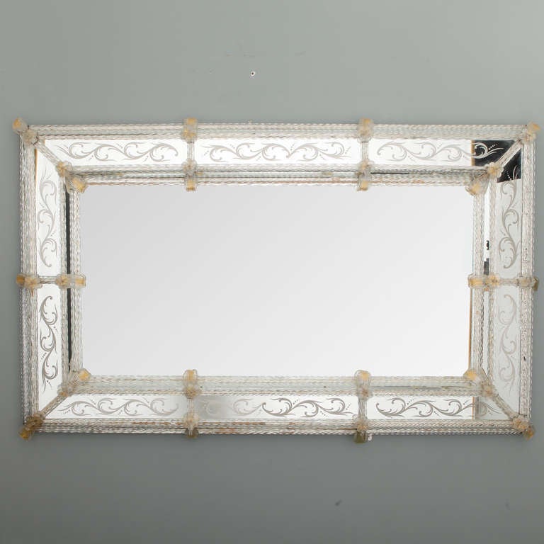 Circa 1940s Venetian mirror has a double frame of twisted glass rods, etched details and gold dusted leaf and flower ornaments.