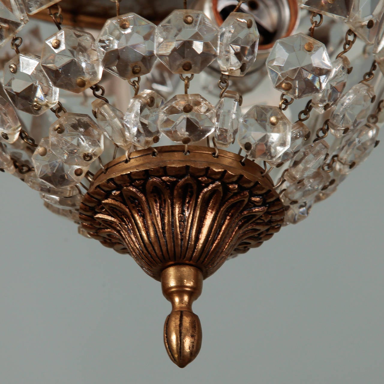 Found in France, this flush mount fixture has a gilded bronze frame with large, clear faceted crystals in a globe form. New electrical wiring for US standards.
# of Sockets:  2
Socket Type:  Regular