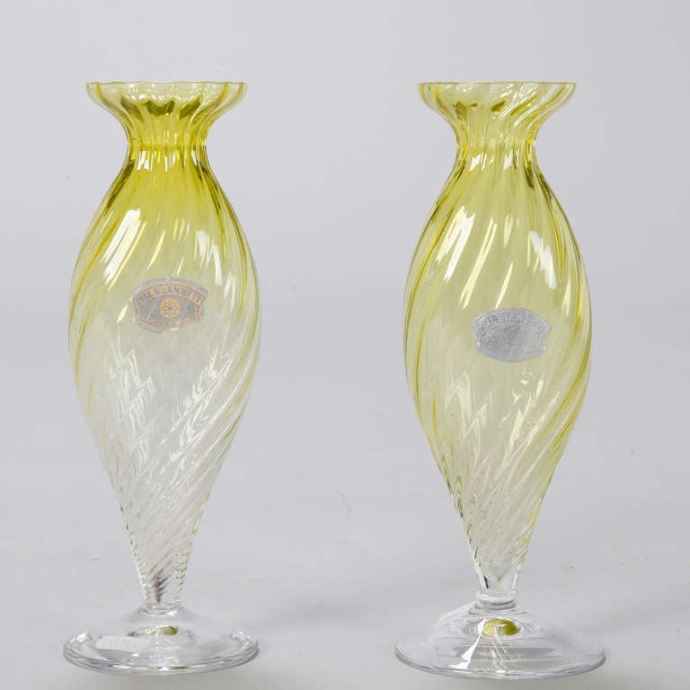 Pair of Val St. Lambert glass vases in striking shade of chartreuse with pedestal base, ribbed body and flared necks, circa 1950s. Original labels attached. Sold and priced as a pair.