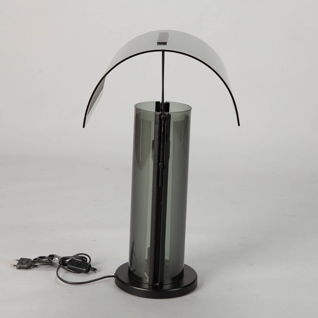 Circa 1960s / 1970s all glass table lamp in a smoky gray shade with cylindrical base and curved shade. Wiring has been updated for US electrical standards.