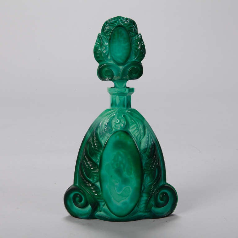 Circa 1930s Czech malachite glass decanter with elaborate, decorative stopper and five matching glasses. Sold and priced as a set.
