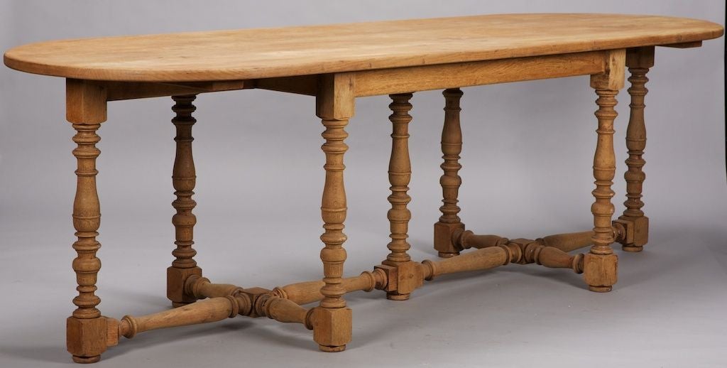 This very large French oval oak table dates from 1890 and has 7 legs. Turned legs and stretcher.