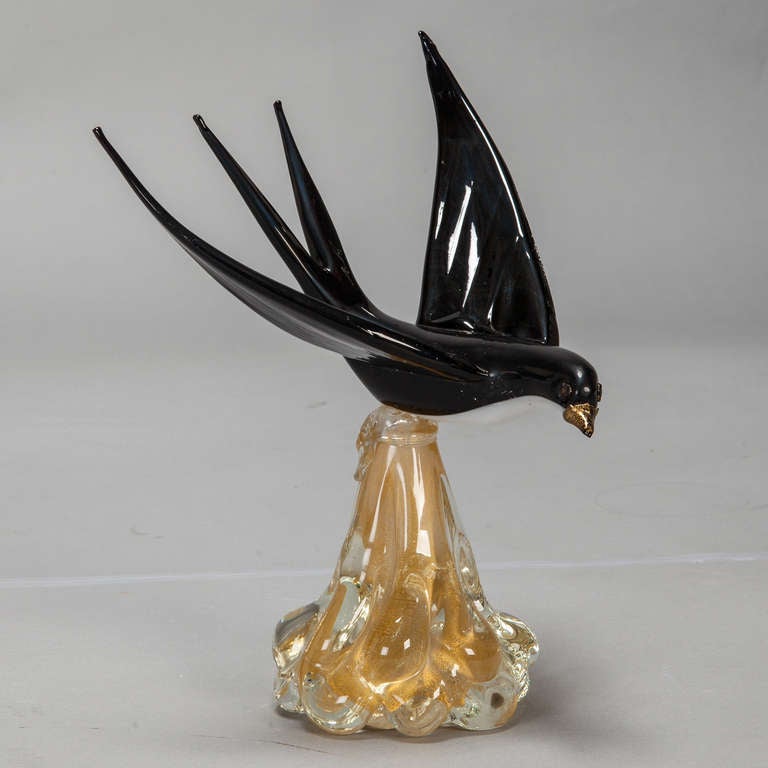 Handblown Murano glass black bird with open wings and a gold beak on a pedestal shaped base. Original retailer's tag attached to bottom, circa 1970s