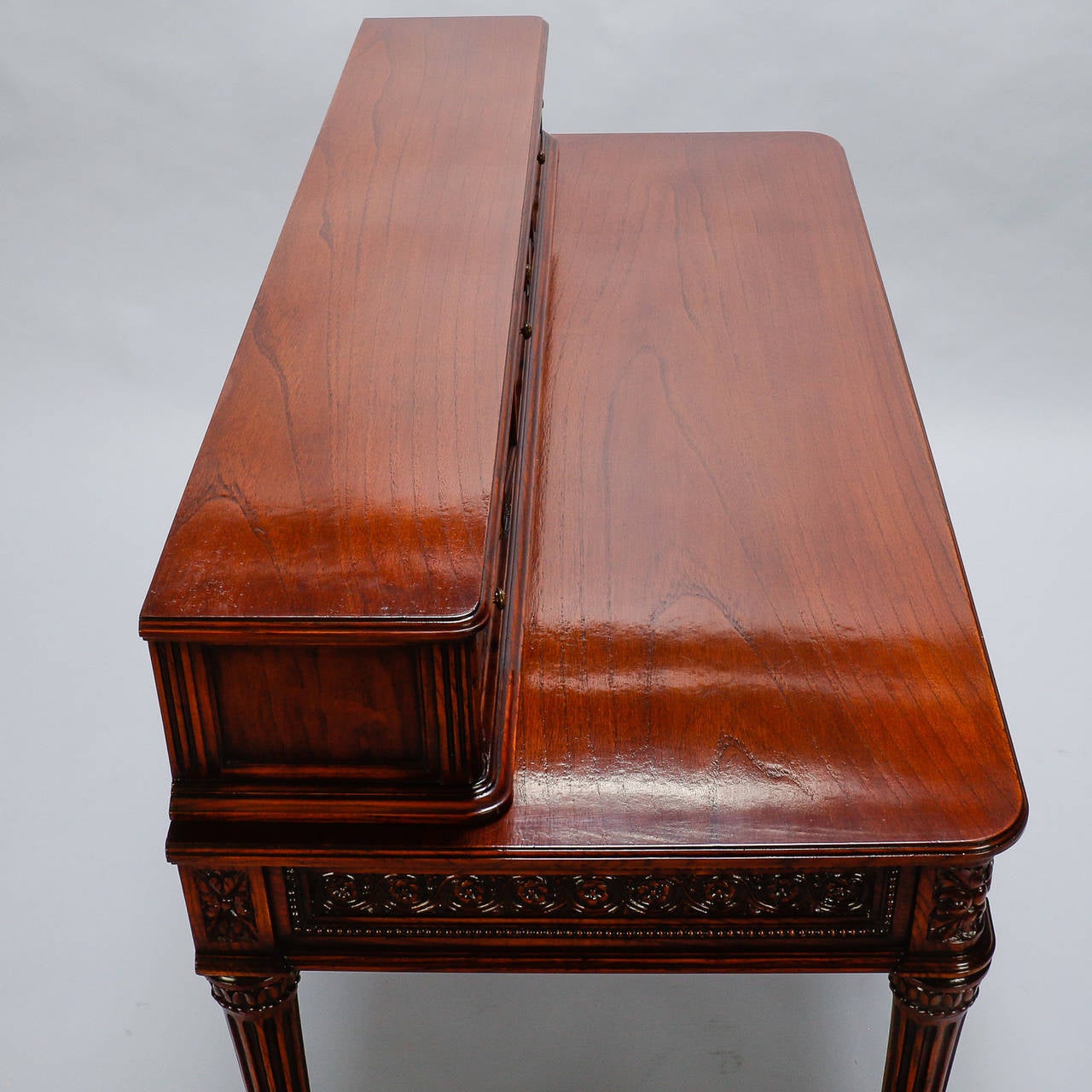 This elegant French ladies writing desk dates from the 1920s and is loaded with beautiful details. The back plinth has three sections of two small functional drawers separated by two small hinged compartments. Beneath the writing surface are three
