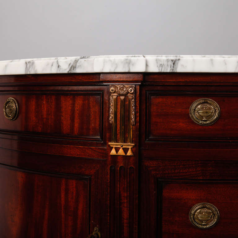 Midcentury directoire style, demilune chest in dark, beautifully grained walnut with a white and gray marble top. Each side has a narrow top drawer with locking hinged cabinets below. Center section has a top narrow drawer and two deeper drawers
