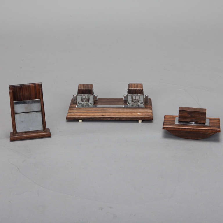 Circa 1930s French three piece rosewood and chrome Art Deco desk set with blotter, double inkwell, and caddy. Sold and priced as a three piece set.