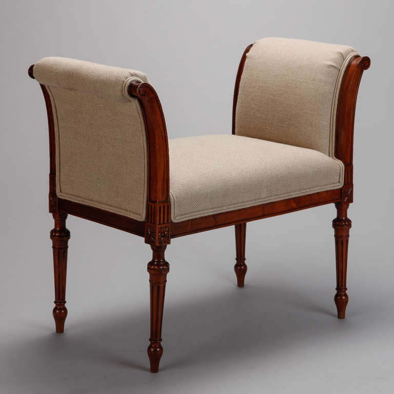 French stool or bench with beechwood frame, turned details on the legs and tall, curved sides, circa 1900. Newly upholstered in natural colored Belgian linen with double welt trim. Seat is 16