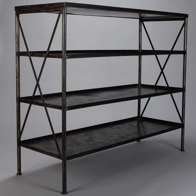 Circa 1930s French iron industrial etagere with four shelves and open X form sides.