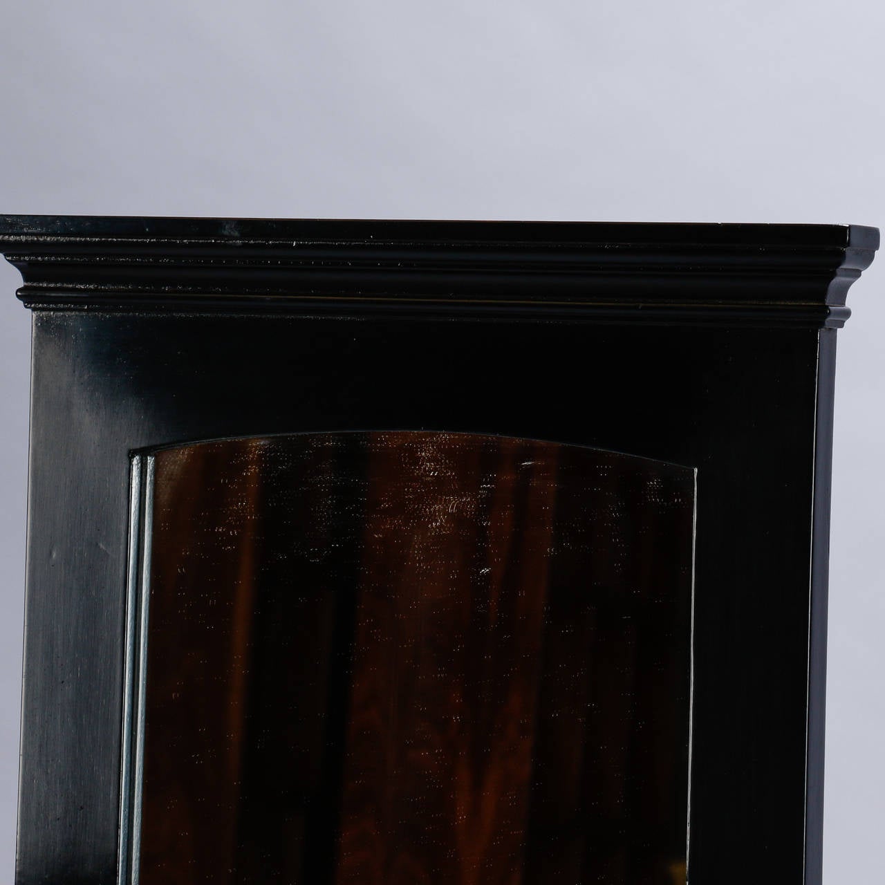 Pair of classically styled mirrors topped with plinths and ebonised finished. Sold and priced as a pair, circa 1950s.