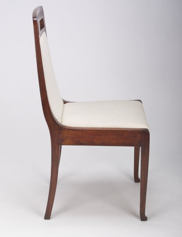 This mahogany side chair from the Art Nouveau era has an upholstered seat and back. The top of the seat back features carved sunbursts and a medallion inlay with mother-of-pearl. This elegant and sturdy chair is finished in muslin - ready for the