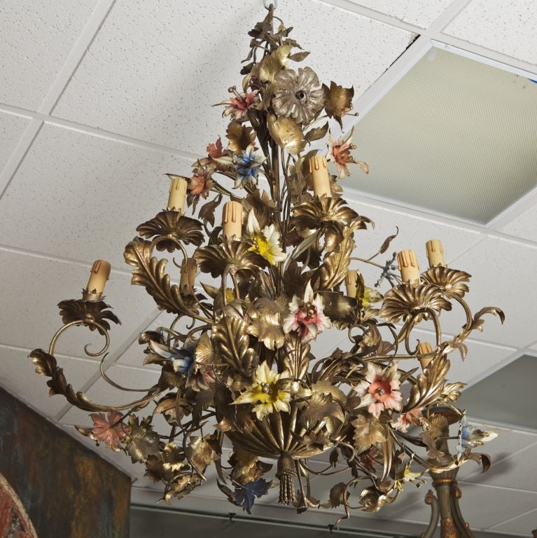 Circa 1900, this large French chandelier has 12 lights in two tiers and features beautifully rendered metal lillies in pink, blue, and yellow with gilded leaves.
# of Sockets:  12
Socket Type:  Candelabra