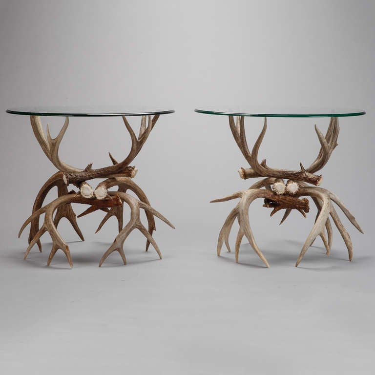 Pair of end tables with bases made of vintage, deer antlers in natural color and finish. Each base consists of three pair deer antlers and is approximately 21
