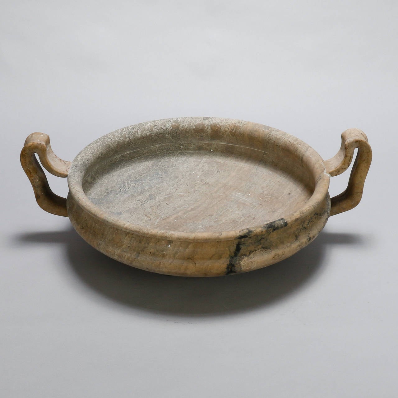 Italian centerpiece dates from the 1930s and features a large, shallow bowl with open work handles hand-carved from a piece of creamy alabaster with some gray veining.

Dimensions:
6” H x 26” W x 9” D.

Retail: $3,495.00.