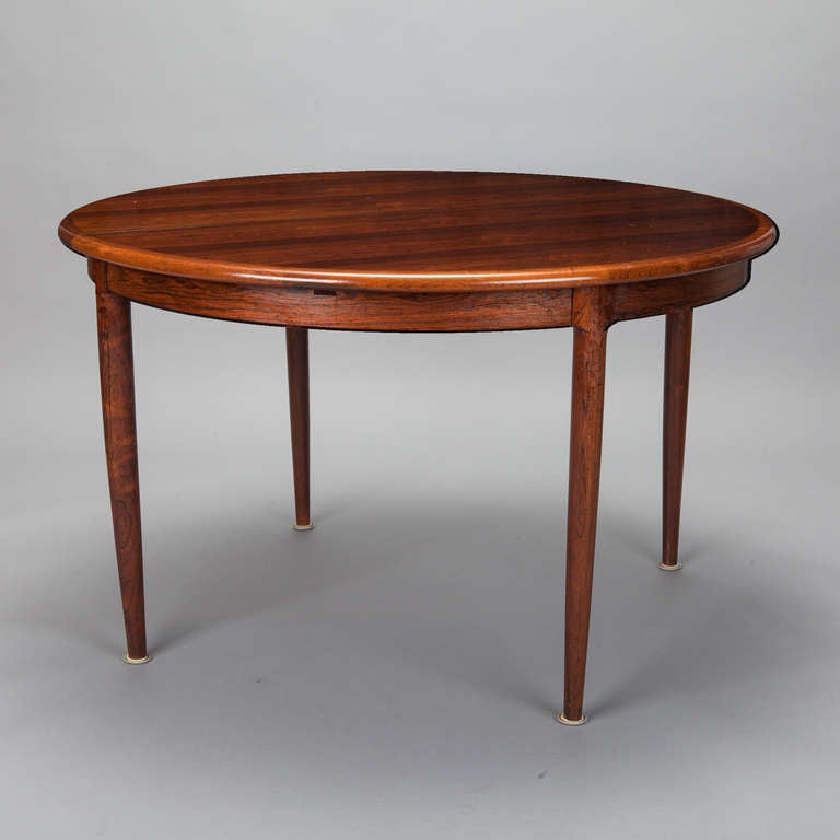 Designed by Niels Moller for J Moller, this #15 dining table is round when closed and expands into an oval when the 20