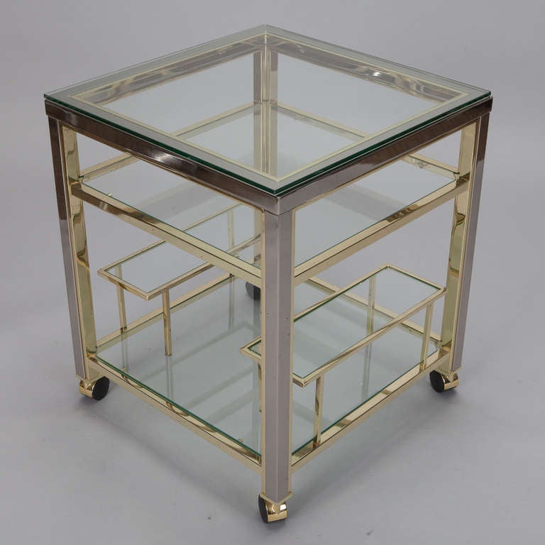 Circa 1960s brass framed bar cart / trolley with bottle racks and two glass shelves.