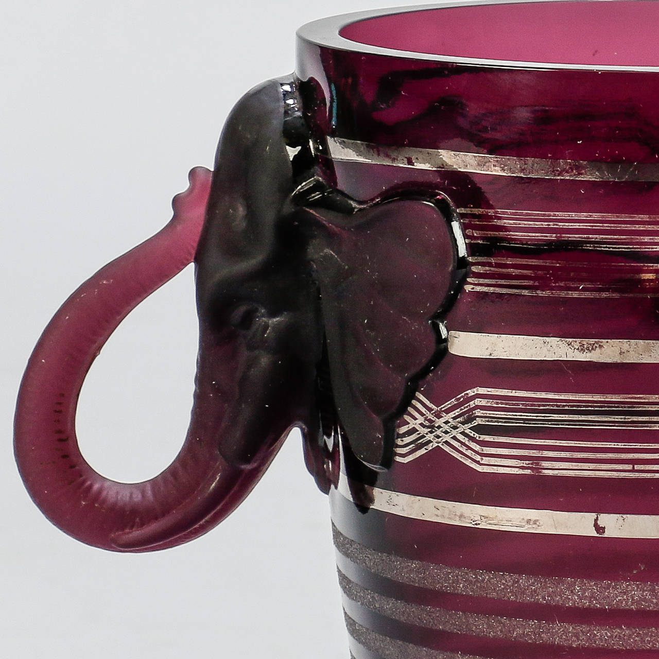 7240 Amethyst Art Glass Deco Era Vase With Elephant Handles

Dating from 1930s, this art glass vase is a rich amethyst color in a classic amphora shape with elephant heads and trunks forming the handles. Stunning.