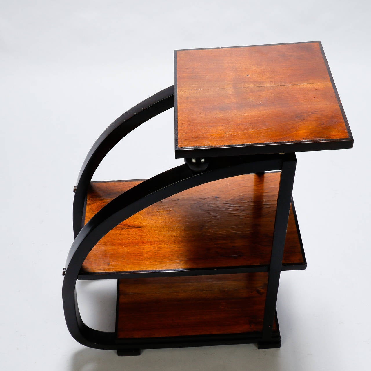 Circa 1930s French side table in wood that appears to be walnut with contrasting ebonised bentwood frame and three tiers.