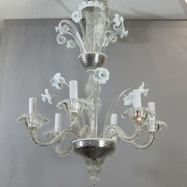 Venetian glass chandelier consists of handblown elements in clear and opaque white glass, circa 1930s. Ceiling canopy is clear glass with white petal edge. Top tier of white daffodil blooms with clear stems and curled leaves. The lower tier has six