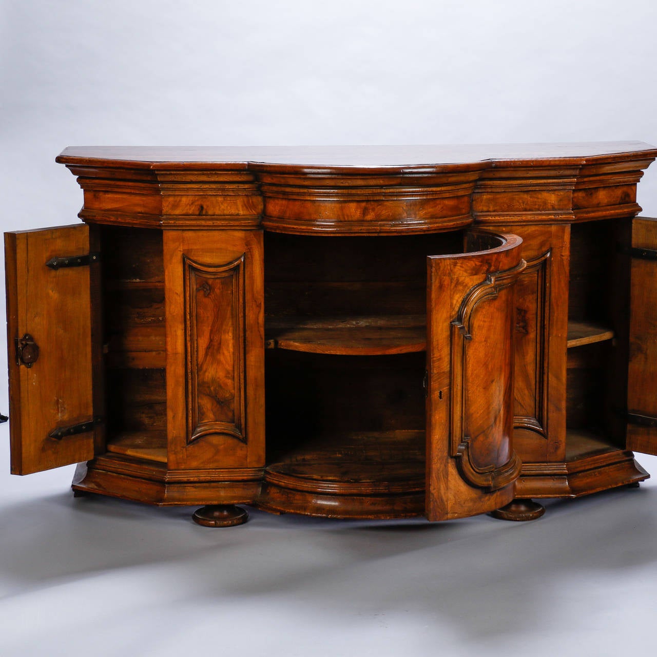 Burl walnut cabinet with rounded front and locking storage compartments, circa 1860s. Nicely figured walnut with curvy, three section rounded base. Hinged storage cabinets have functional locks and original keys. Original escutcheons not present.
