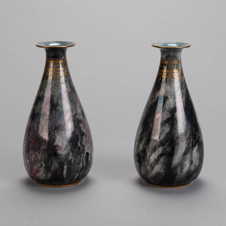 This pair of circa 1930s Losol Ware vases has a glossy marled gray and white glaze with streaks of burgundy. Decorative gilded band around the necks and gilded rims. Marked Losol Ware  Keeling & Co. Burslem on the bottom. Sold and priced as a pair.