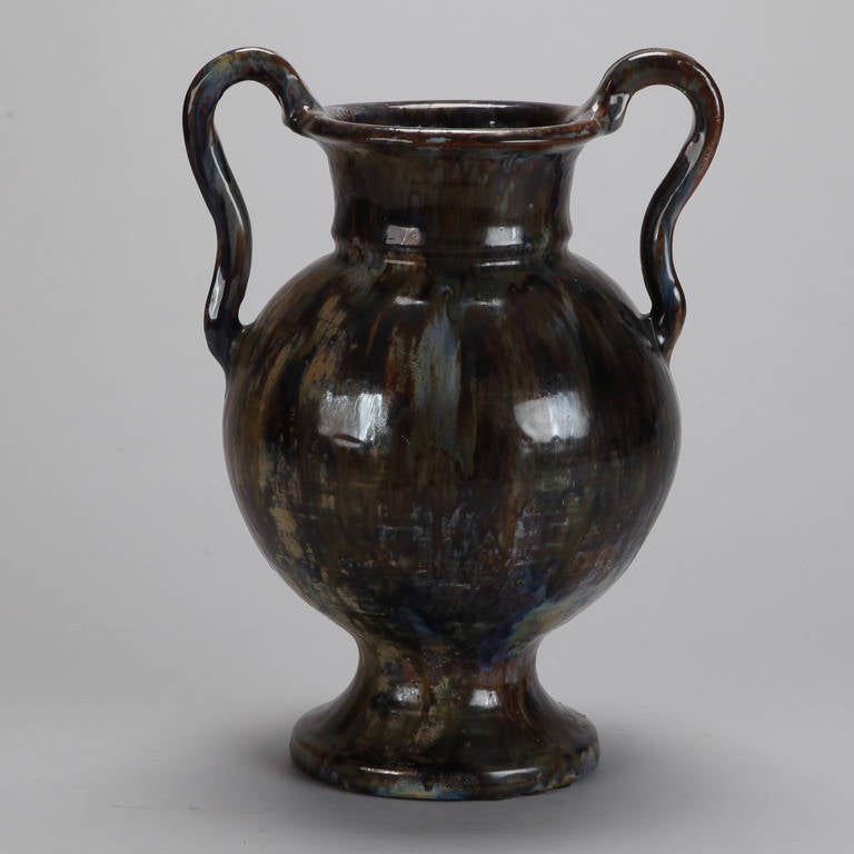 Circa 1920s French vase in classic amphora form with pedestal base, round vessel body and two handles. Earthy, streaked glaze with shades of bronze, green, brown, gray and blue.