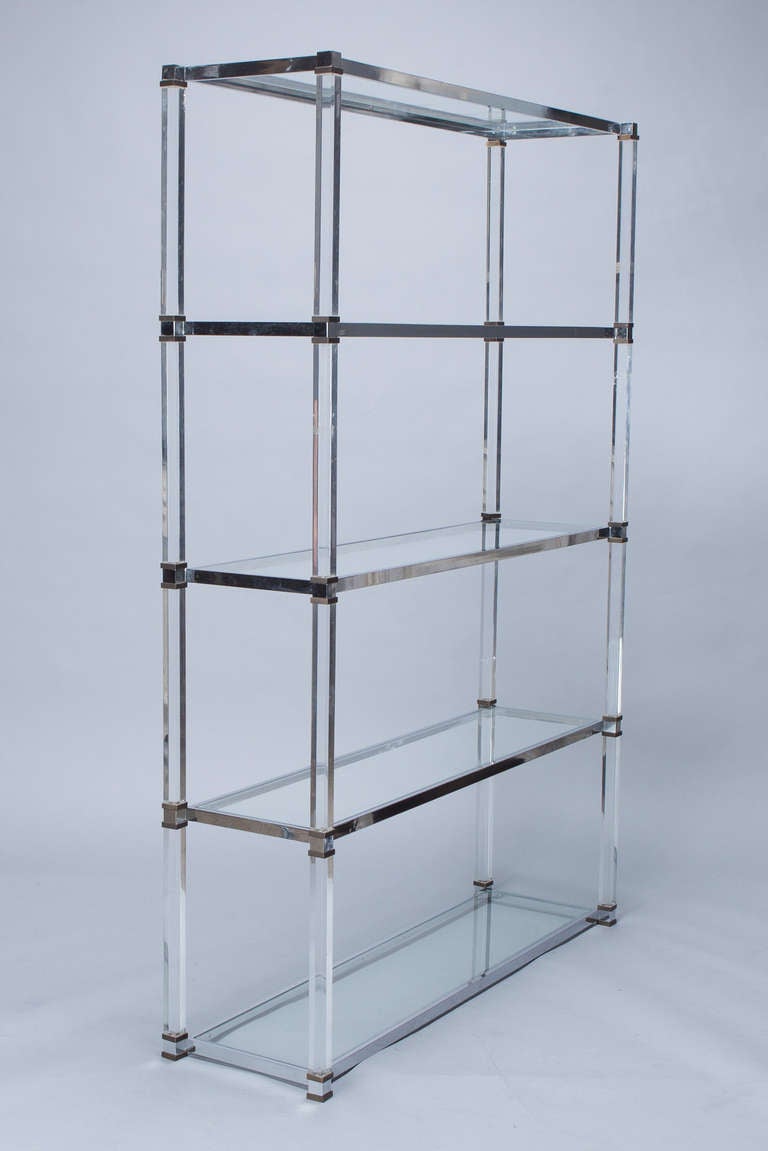 Mid century open shelving unit / etagere by Italian designer Romeo Rega with brass fittings, Lucite supports and glass shelves.