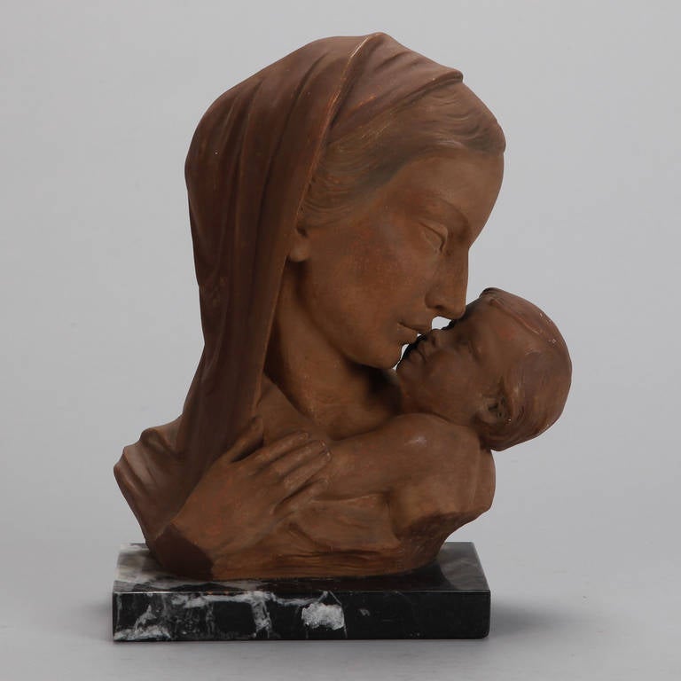 Circa 1930s terra cotta bust of mother and child mounted on marble base and signed by Belgian artist Johanne Dommisse.