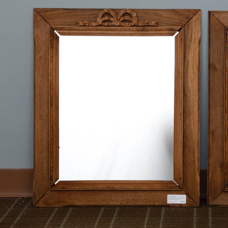 Circa 1920s French bleached wood frame mirror with carved bow and ribbon crest. Three available. Sold and priced individually.

2 = 21.75