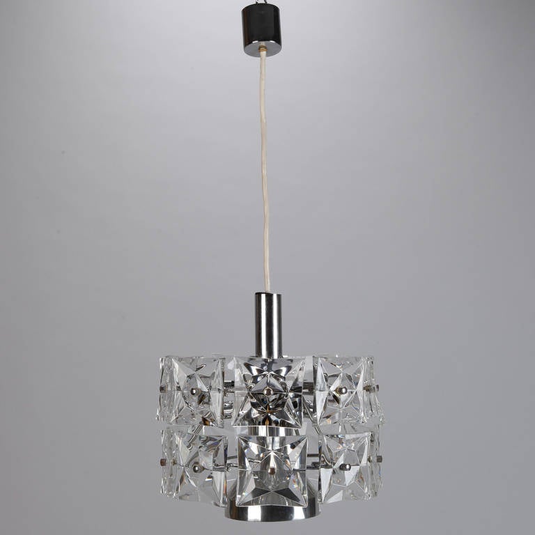 Hanging crystal fixture attributed to Austrian maker Kinkeldey has square faceted crystals and a chrome and nickel base, circa 1970s. Fixture has a single regular size bulb holder and six vertical candelabra sockets. New wiring for US electrical