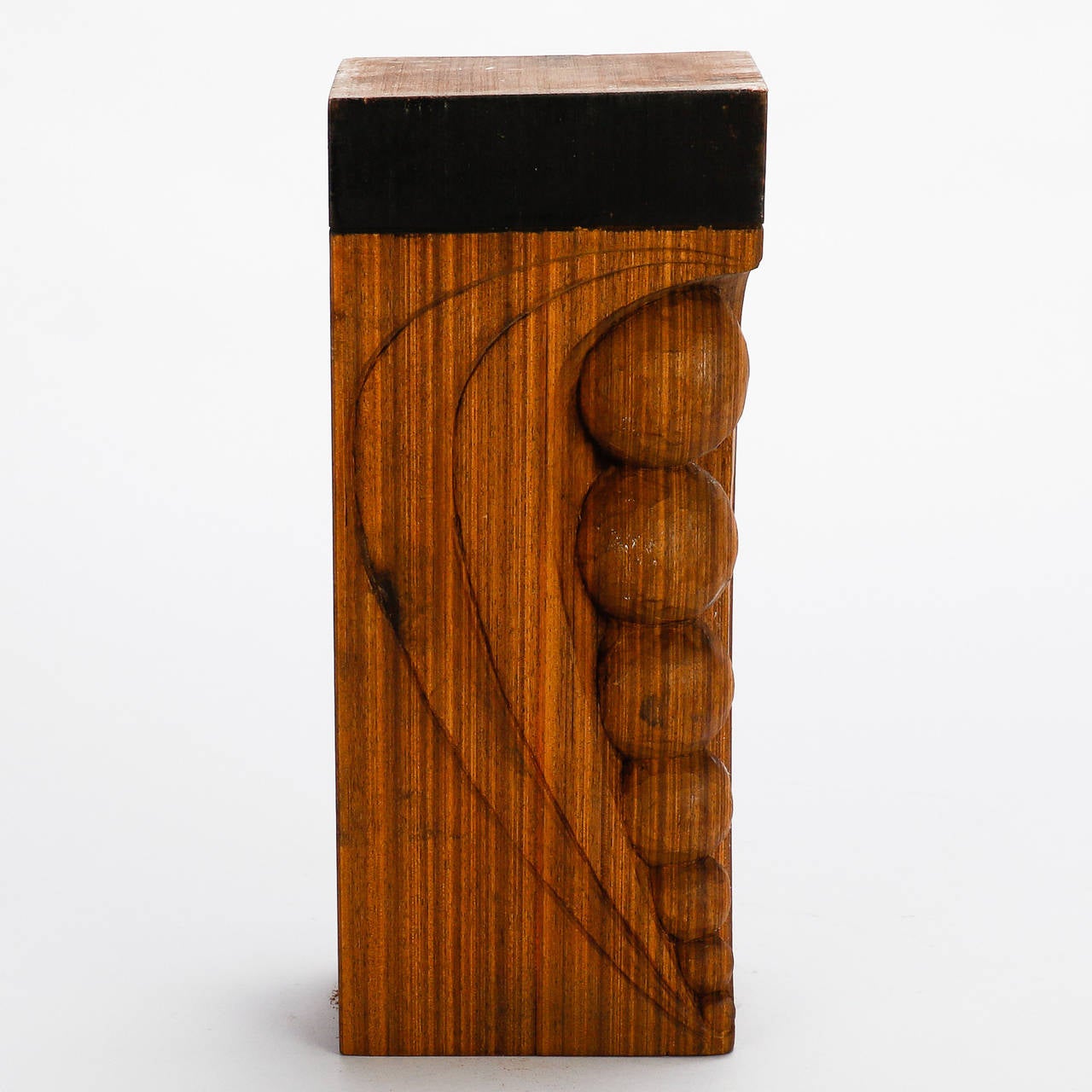 This mid century wood sculpture by Italian artist Flaviano Laghi dates from approximately 1980 is mounted on a dark wood base and features a light wood with prominent graining in a block form with graduated carved beads at one corner. Other carved