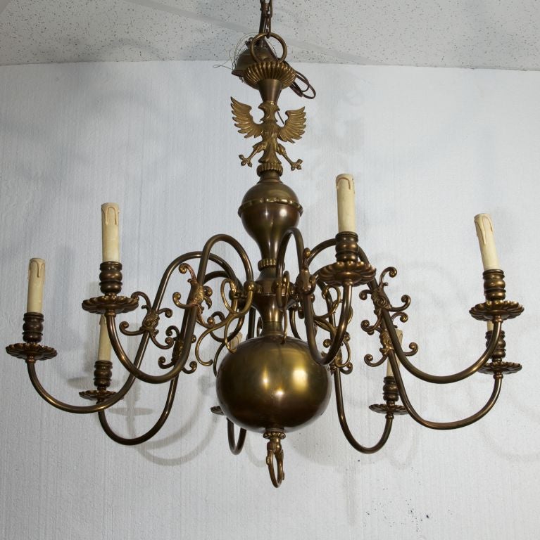 Eight arm bronze chandelier with large round base and topped with an eagle.
# of Sockets:  8
Socket Type:  Candelabra