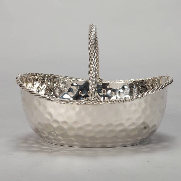 Circa 1960s Nickel Plated basket. Found in France, the basket has a hammered metal surface texture with a thick, rope twist form handle and finer rope twist border around the upper edge.