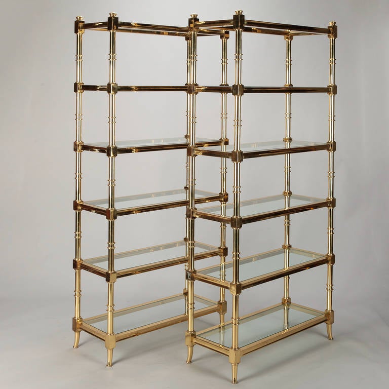 Solid brass frame Italian étagères with clear glass shelves, circa 1950s. Sold and priced as a pair.
