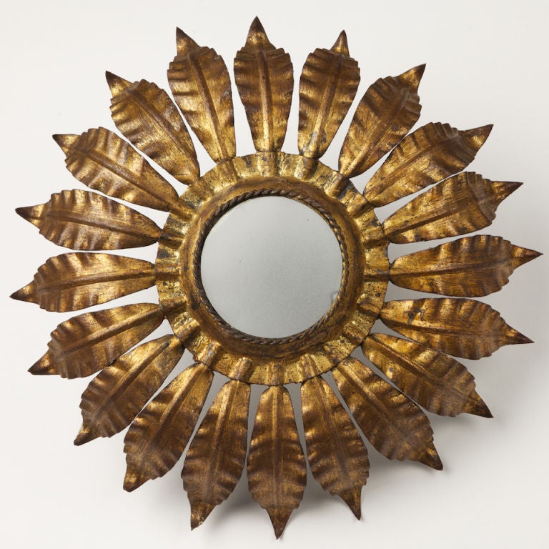 Single light gold gilt metal single light sunburst ceiling light with large curved rays.