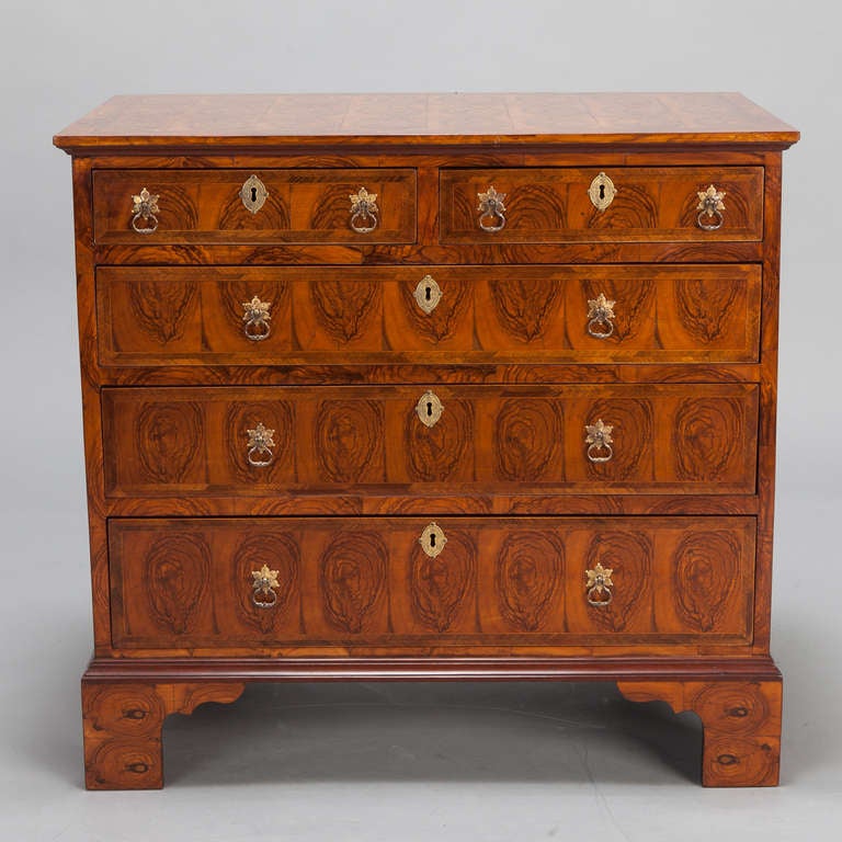 Circa 1880s English chest of five drawers with oyster veneer and brass hardware.