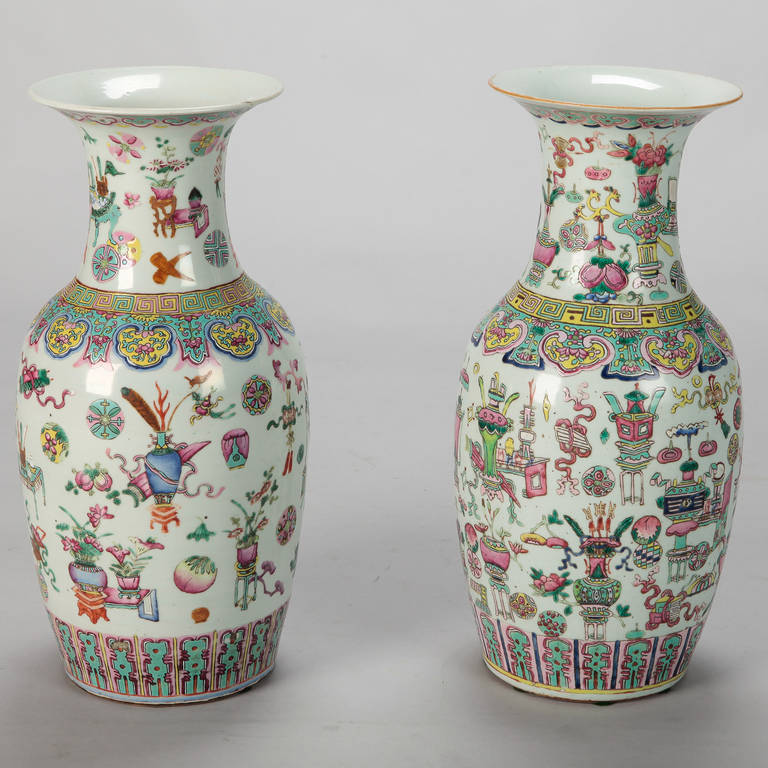 Circa 1930s pair of Chinese vases just under 18” tall with white background, decorative borders at the flared neck, base and shoulders. Sold and priced as a pair.