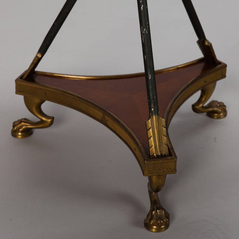 Circa 1900 pair of French round side tables made of wood with brass ornamental mounts, pull out swivel drawers, mirrored glass tops set in brass foliate frames, iron tripod arrow form supports accented with brass and set in a wood and brass base