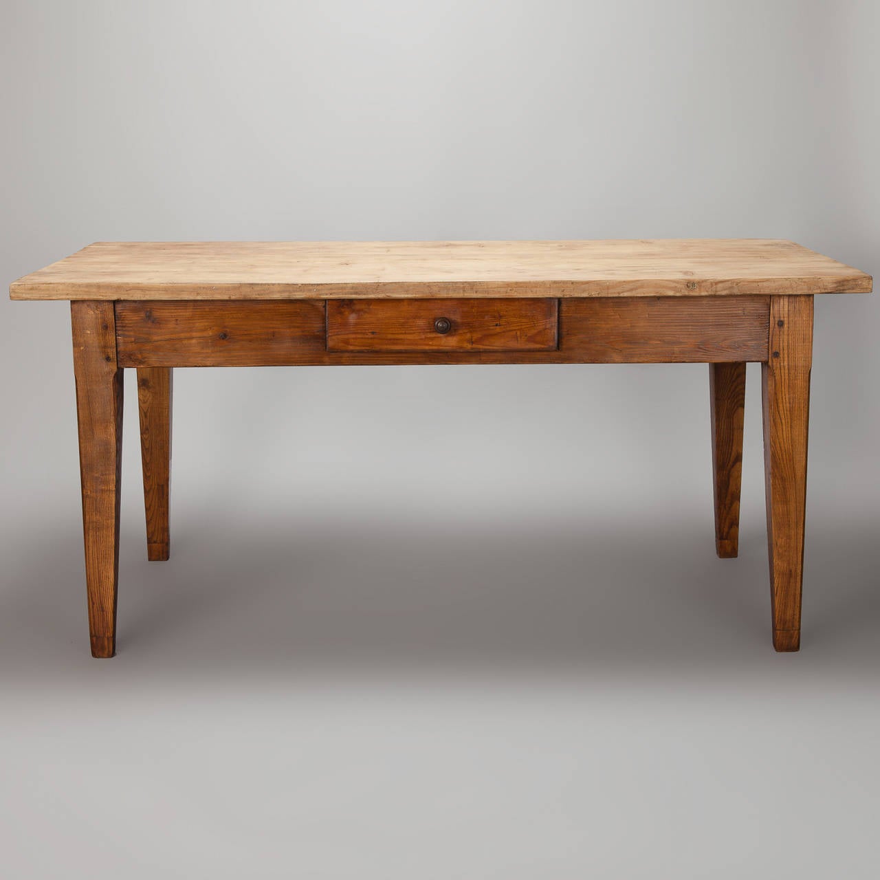 Circa 1860s French farm table has a pine table top and painted ash base with a single center drawer. Versatile size is perfect for a breakfast room, kitchen or for use as a large, rustic desk.