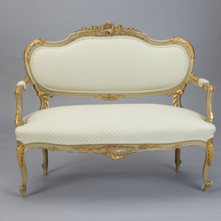 Circa 1870 settee has a painted and gilded frame, padded arms and new upholstery.  Beautiful condition. Matching pair of fauteuils available under separate listing.
Arm Height:  26”
Seat Height:  20”
Seat Depth:  23”
