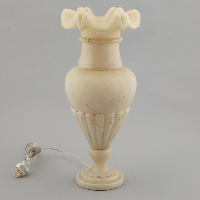 Found in France, circa 1950s-1960s all alabaster lamp has urn shaped base and removable ruffled/scalloped edged top piece.