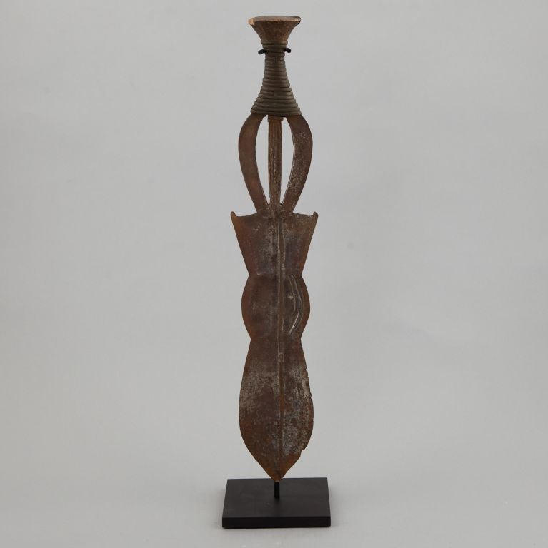 Circa 1930s ceremonial blade with rusted finish, sculptural shape.