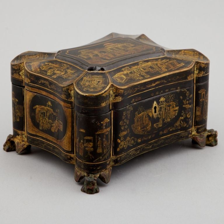 Elaborately painted and decorated 19th century Chinese tea caddy made for the English market. Beautiful gilded details, carved dragon shaped feet and two metal tooled lidded tea canisters.